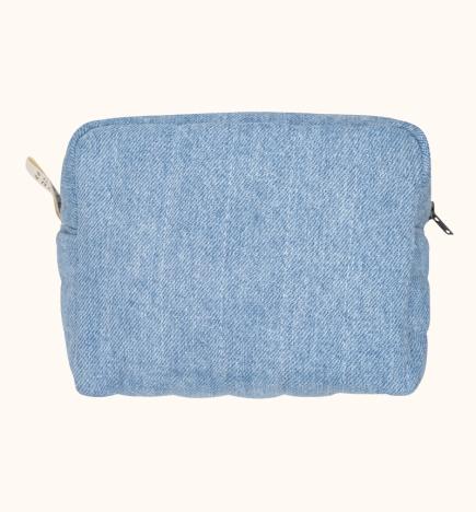 Denim toiletry bag with small exterior pocket.