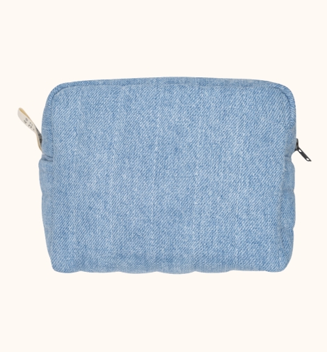 Denim toiletry bag with small exterior pocket.